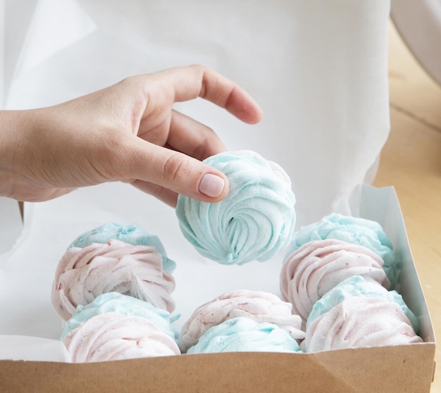 Young cook woman packs pastries in a box Small home business