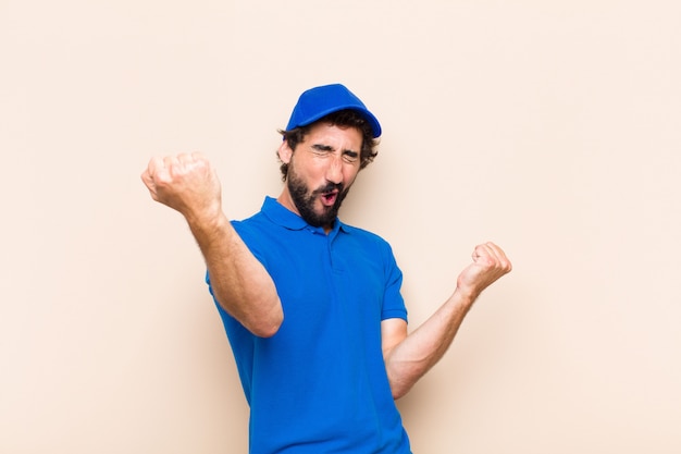 Young cool bearded man celebrating a victory