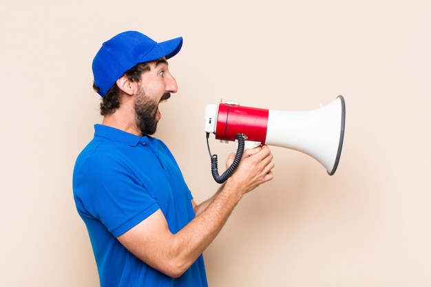 Young cool bearded man with a megaphone