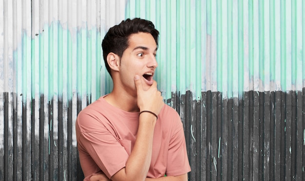 Young cool man against grunge background