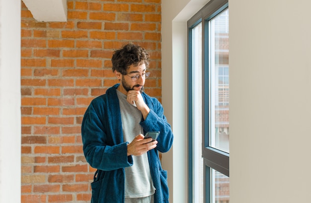 Young cool man waking up at home wearing pajamas