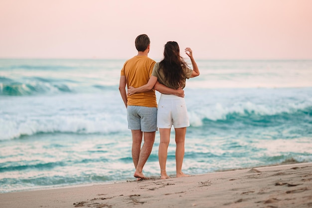 Young couple on the beach vacation in Florida at sunset