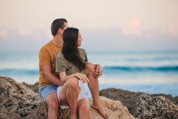 Young couple on the beach vacation in Florida at sunset