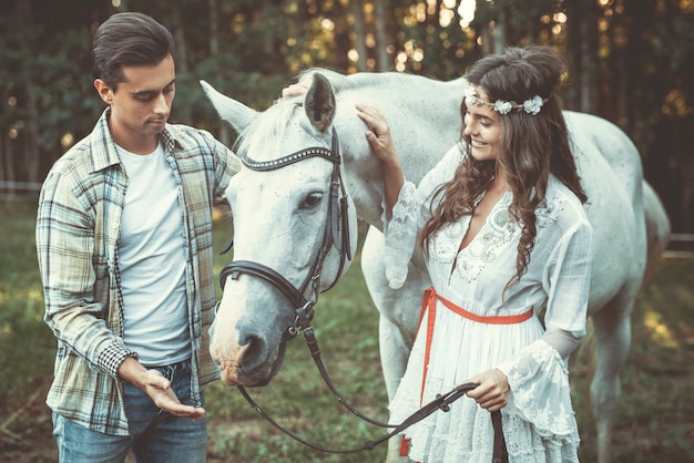 Young couple and beautiful horse