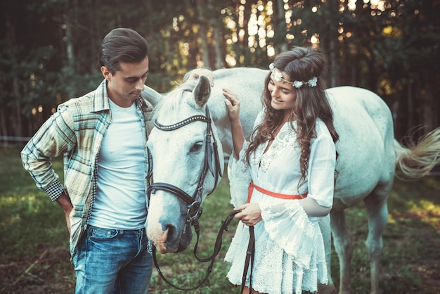 Young couple and beautiful horse