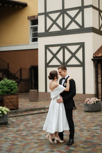 Young couple bride and groom in a white short dress