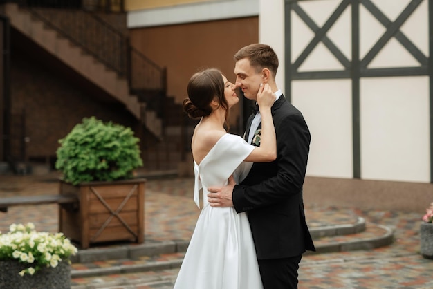 Young couple bride and groom in a white short dress