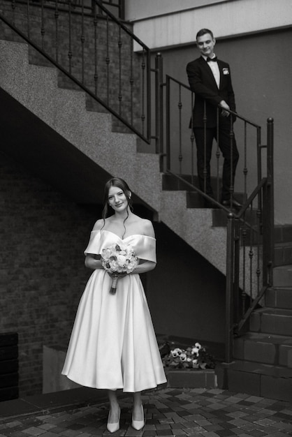 Young couple bride and groom in a white short dress