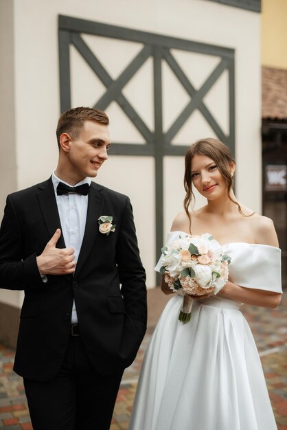 Young couple bride and groom in a white short dress