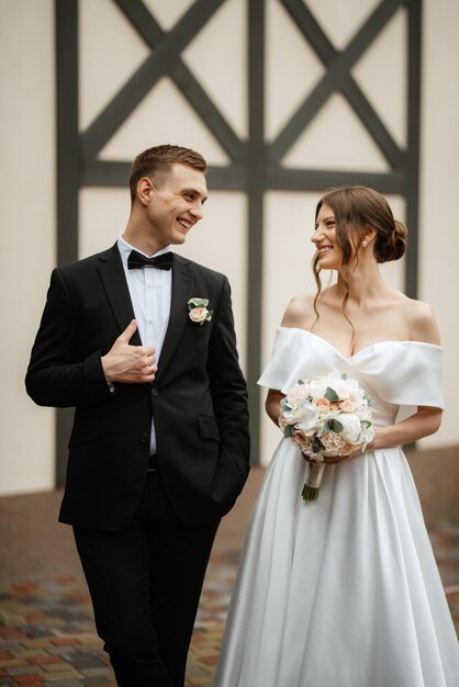 Young couple bride and groom in a white short dress