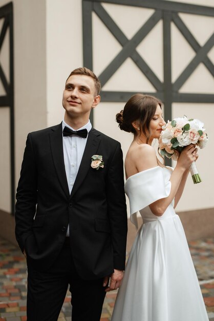 Young couple bride and groom in a white short dress