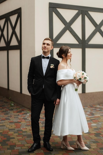 Young couple bride and groom in a white short dress