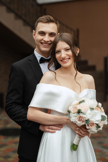 Young couple bride and groom in a white short dress