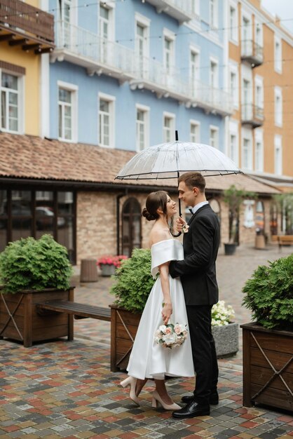 Young couple bride and groom in a white short dress