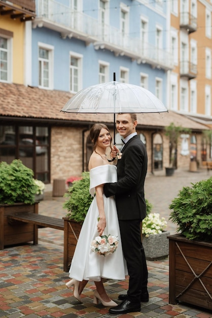 Young couple bride and groom in a white short dress