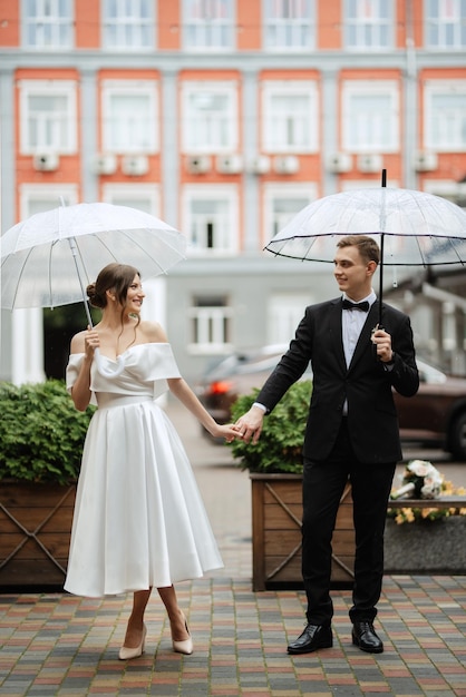 Young couple bride and groom in a white short dress