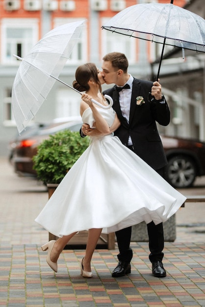 Young couple bride and groom in a white short dress