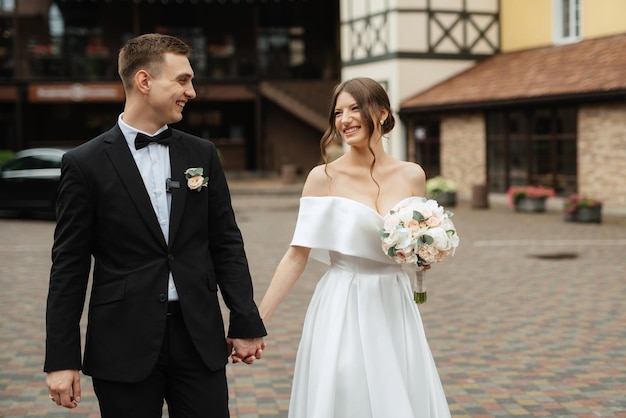 Young couple bride and groom in a white short dress