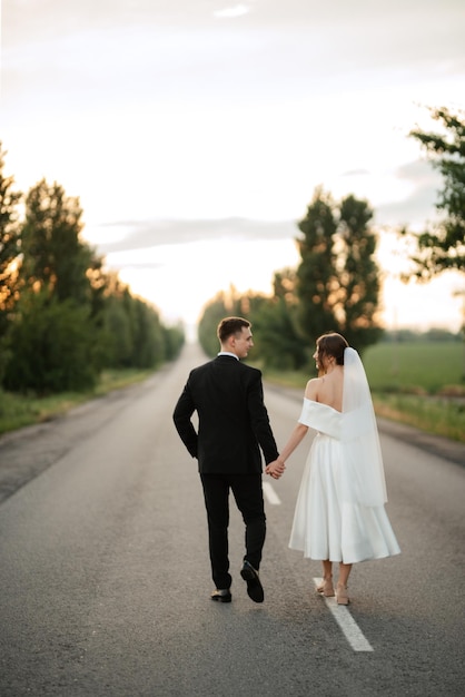 Young couple bride and groom in a white short dress