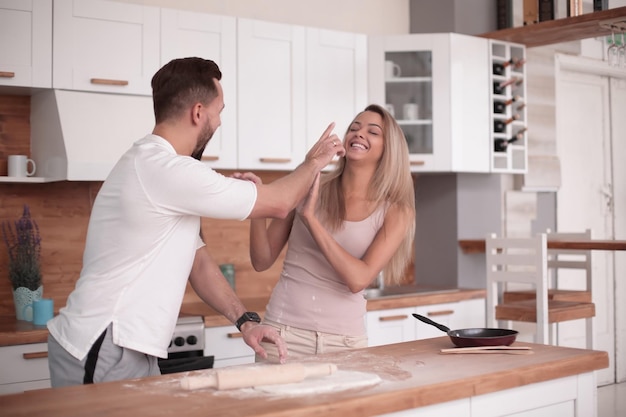 Young couple communicates in the home kitchen