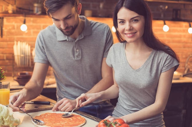 Young couple cooking in kitchen