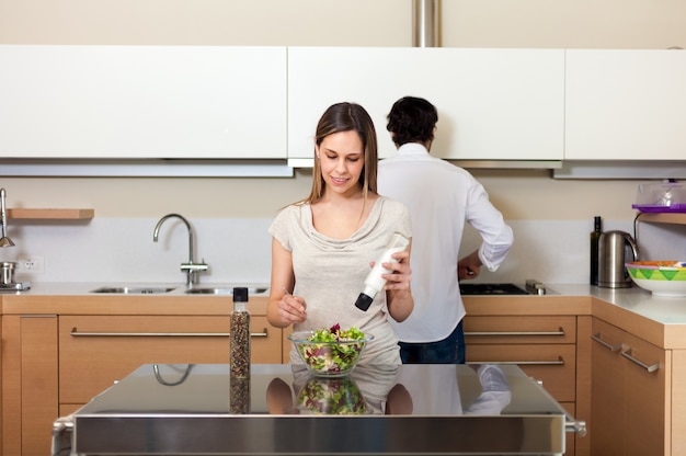 Young couple cooking in their kitchen