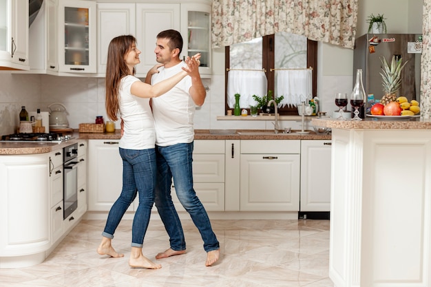 Young couple dancing in kitchen