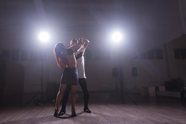 Young couple dancing latin dance Bachata, merengue, salsa. Two elegance pose in dance class.