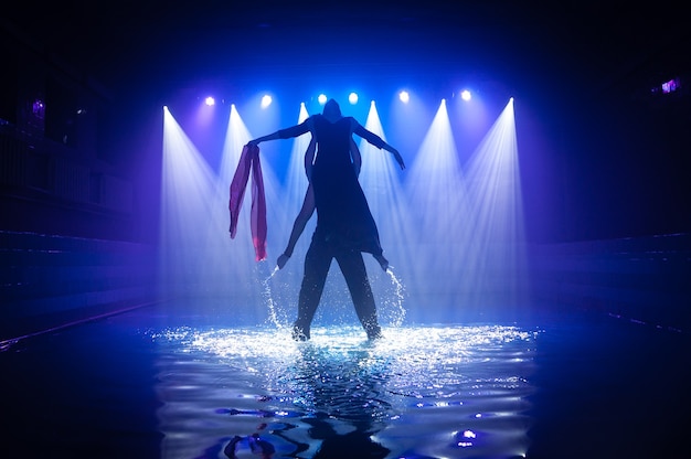 Young couple dancing in the water.