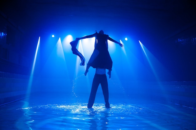 Young couple dancing in the water.