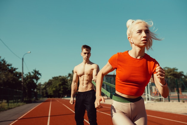 Young couple doing sports with sports rubber bands