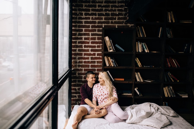 Young couple embracing on bed at bedroom