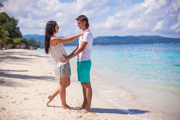 Young couple enjoying their vacation and have fun on a tropical beach