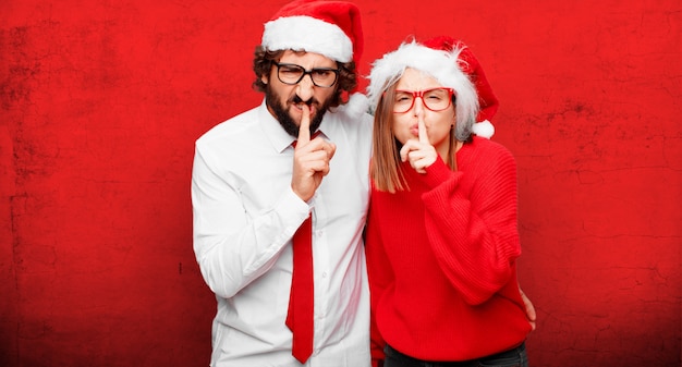 Photo young couple expressing christmas concept. couple and background in different layers