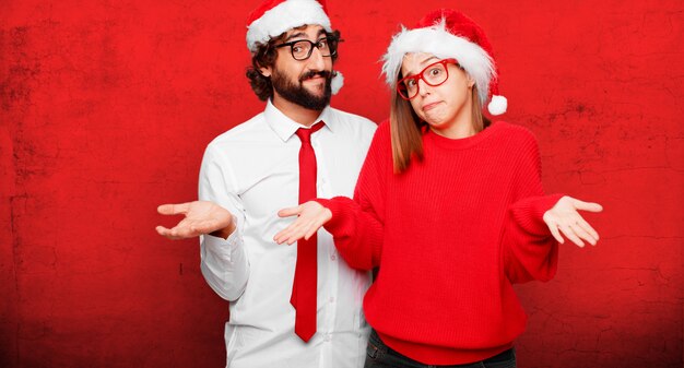 Young couple expressing christmas concept. couple and background in different layers