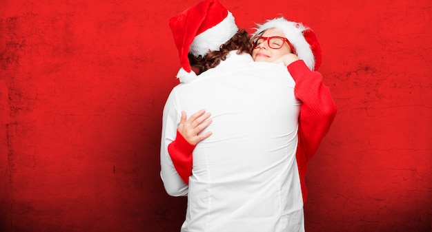 Photo young couple expressing christmas concept. couple and background in different layers