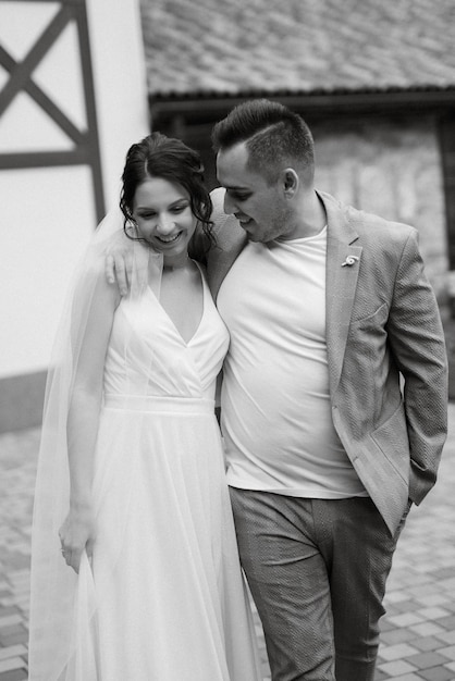 Young couple the groom in and the bride on a walk