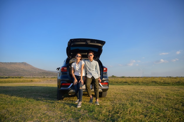 Young couple happy asian out on a road trip.