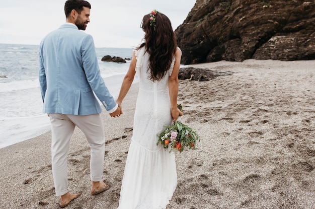 Young couple having a beach wedding