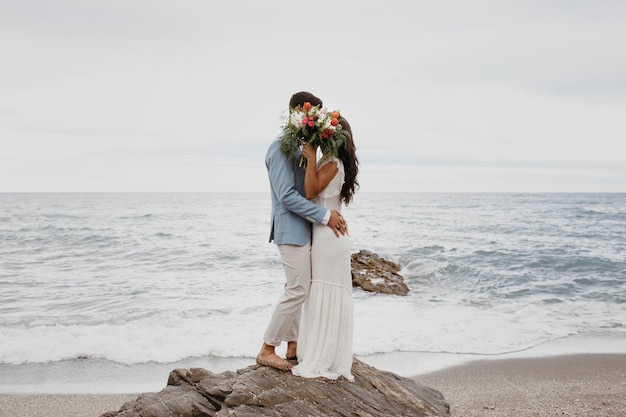 Young couple having a beach wedding