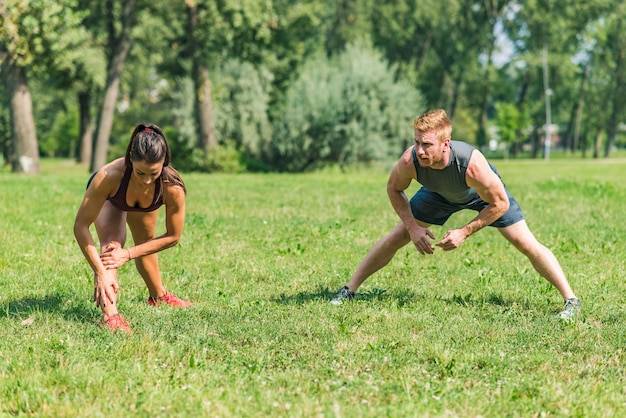 Young couple having exercise in the park