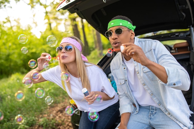 Young couple having fun and making bubbles