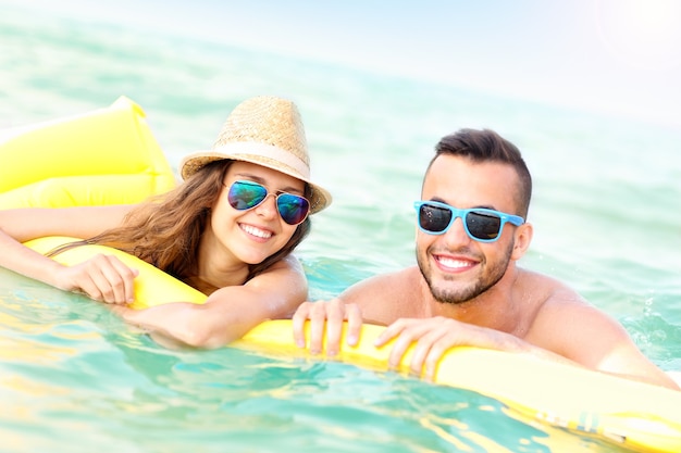 young couple having fun on a matress in the Baltic Sea