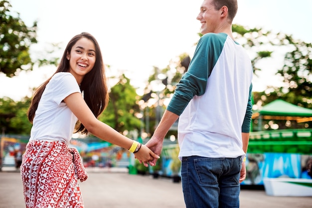 Young couple having fun together at an amusement park