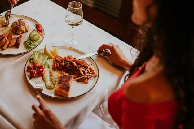 Young couple having lunch with white wine in the restaurant