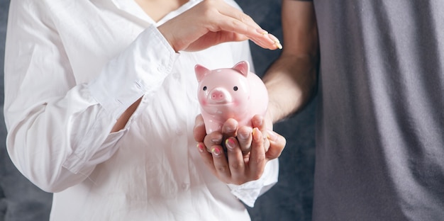 Young couple holding a piggy bank