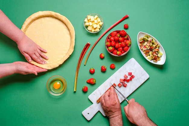 Young couple home baking a pie