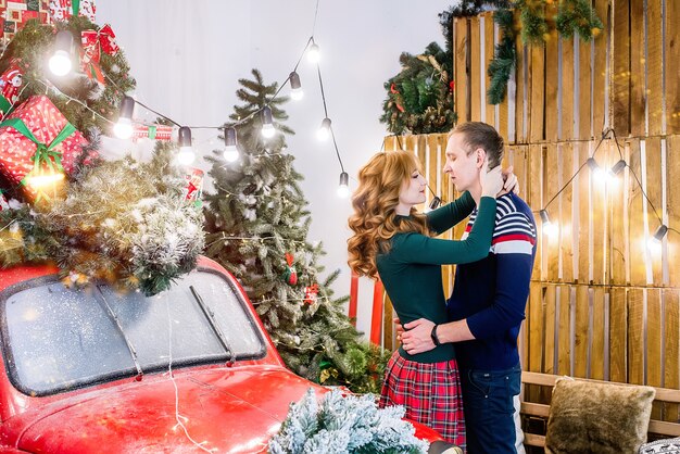 Young couple hugging on the background of Christmas decorations