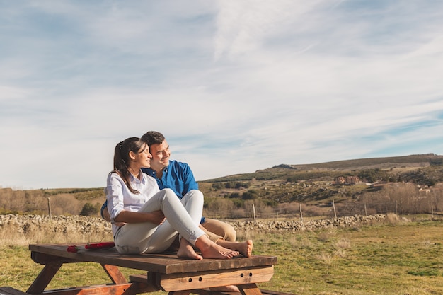 Young couple hugging and enjoying spending time together in the countryside