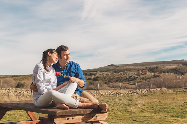 Young couple hugging and enjoying spending time together in the countryside